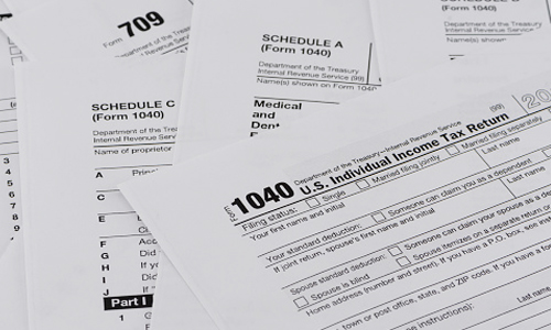 Paperwork and calculator on a desk for tax preparation